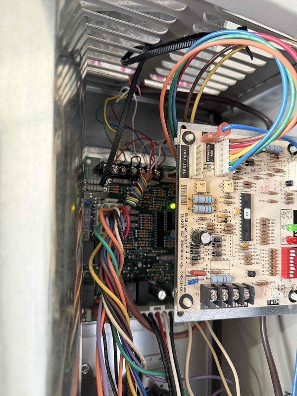 Performed diagnostic inspection on LG system reporting no heat. Examined control board which showed normal operation with illuminated green LED indicator. Traced issue to faulty circuit board connections and repaired loose wiring at terminal blocks, restoring proper heat function.