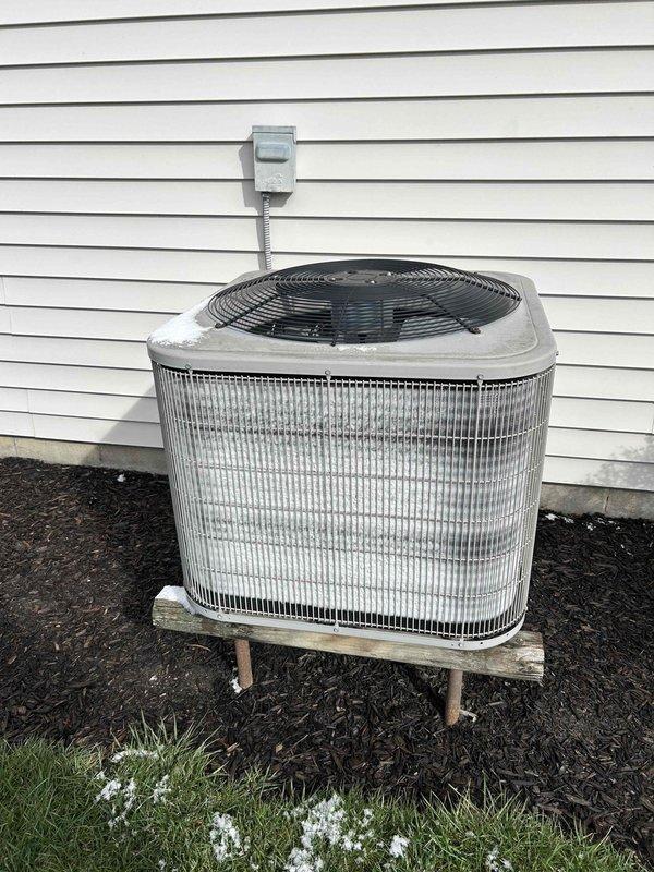 Conducted assessment of 15-year-old HVAC system requiring replacement. Inspected existing Honeywell digital thermostat (functioning properly) and evaluated outdoor AC unit showing signs of age-related wear. System has reached end of serviceable life and replacement recommended based on equipment condition and age.