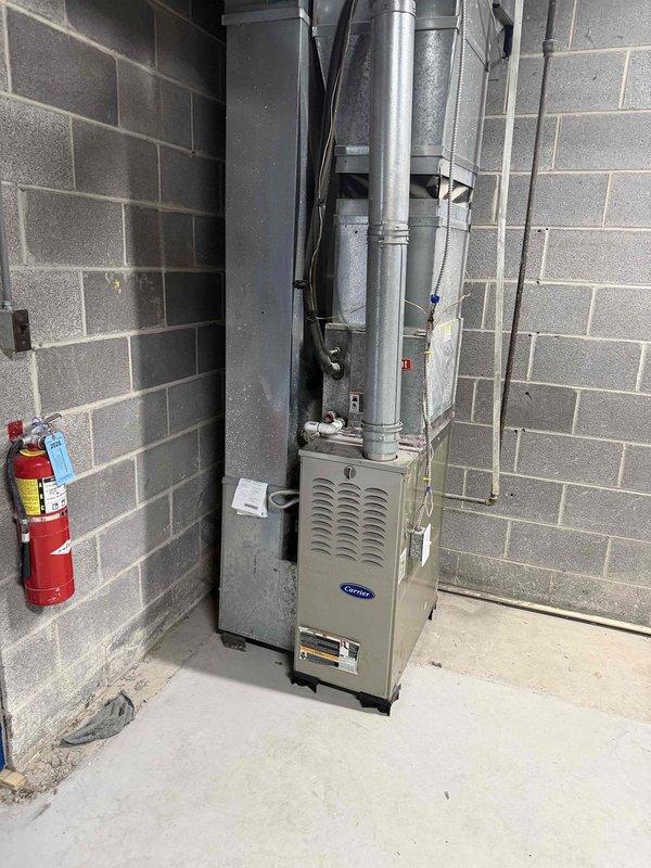 Conducted comprehensive equipment assessment to develop maintenance plan for multiple HVAC systems across two buildings. Documented Carrier furnace unit in Building A and dual Goodman furnaces in Building B, capturing specifications including filter dimensions and belt requirements. Evaluated hanging heaters for accessibility requirements and included small water heater in inspection documentation. All equipment photographed for maintenance planning purposes.