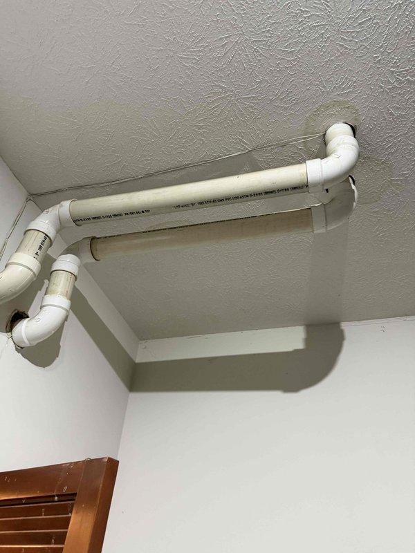 Inspected PVC exhaust/intake venting system after customer reported intermittent heating failure. Observed discoloration and potential condensate buildup at pipe connection points. Cleaned affected areas and verified proper sealing at all joints to ensure proper furnace operation and prevent future exhaust gas leakage.