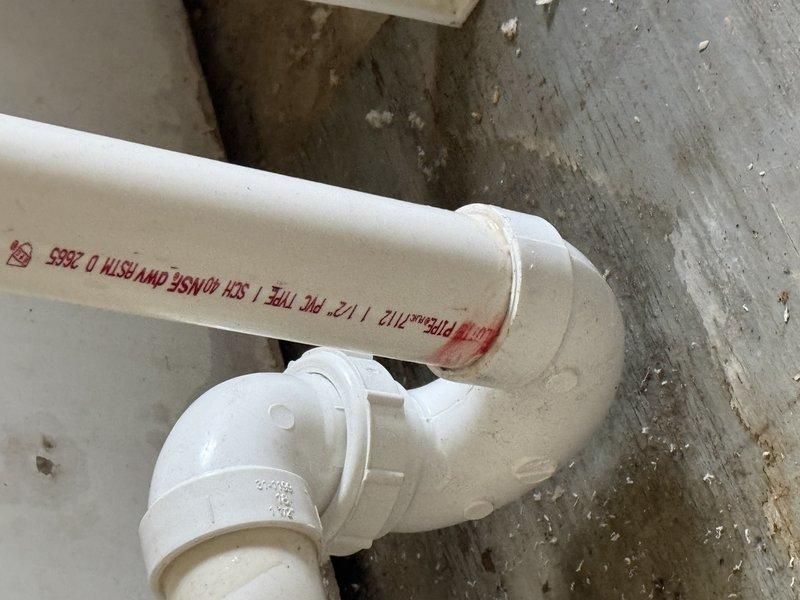 Performed visual inspection of utility room to gather measurements for water softener installation. Documented existing plumbing configuration including PVC drainage pipes and connection points. Evaluated current setup with recently installed HVAC equipment and water heater to determine optimal placement for new water softener system.