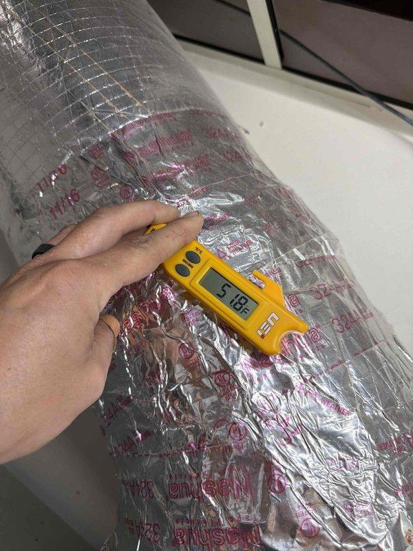 Performed scheduled tune-up service on three HVAC units. Conducted temperature differential measurements using UEi PDT550 digital thermometer, with readings documented at 00.0°F and 5.18°F across the insulated ductwork. Inspected insulation integrity, finding properly secured metallic reflective insulation with no visible damage or deterioration.