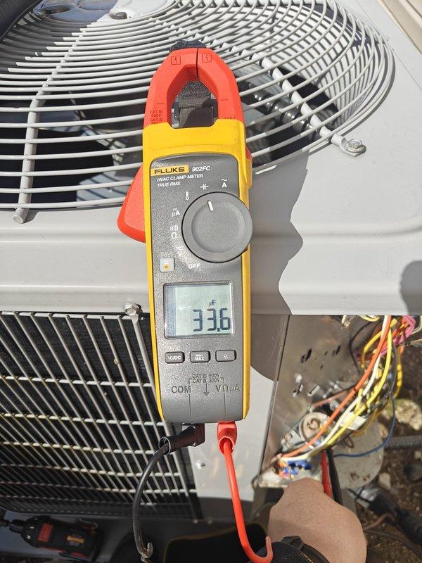 # Service Summary

Completed annual heating maintenance on residential HVAC system. Performed comprehensive system inspection including outdoor condenser unit evaluation, electrical testing, and component verification. Measured electrical parameters using calibrated clamp meter, recording readings of 336 on system components. Inspected condenser coils through protective grille cage, noting clean condition with proper fin spacing. Verified electrical connections and wiring integrity at junction points. All components found operating within normal parameters with no immediate repairs required.