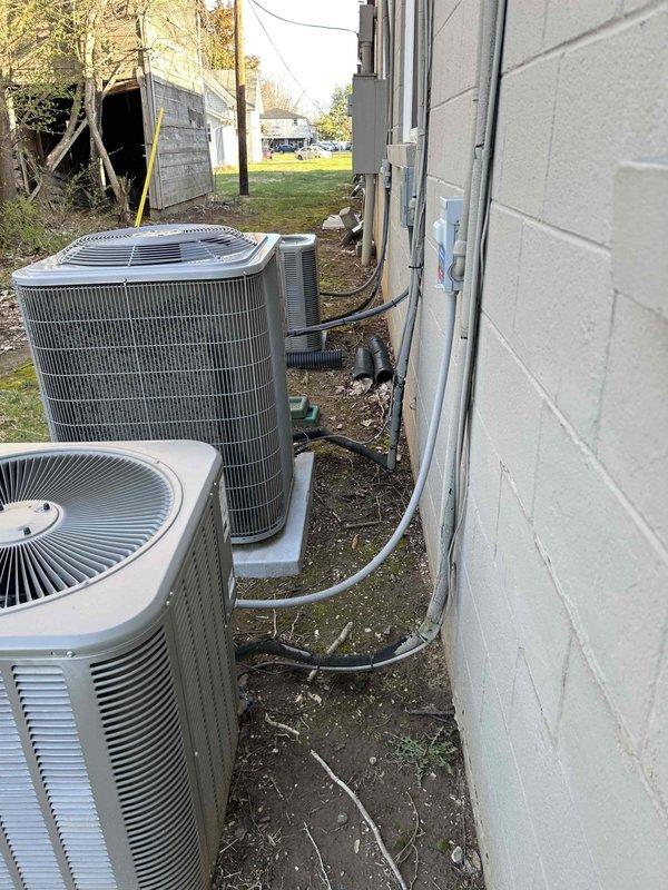 Conducted site assessment at commercial food pantry facility to provide estimate for replacement of two existing furnaces. Inspected current heating equipment and building infrastructure, including electrical panel and outdoor HVAC components. Documented existing conditions showing aging infrastructure with visible corrosion on utility room walls and deteriorating electrical system components. Evaluated exterior condenser units and associated refrigerant lines and electrical conduit installations. Requested tax-exempt documentation for estimate preparation and captured photographic documentation of existing equipment and facility conditions for proposal development.