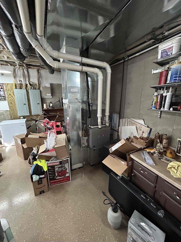 Conducted on-site assessment for complete HVAC system replacement in basement installation. Evaluated existing Heil furnace (100,000 BTU capacity) and documented current ductwork configuration with detailed measurements for proper equipment sizing. Provided estimate for new 3-ton air conditioning system with International condenser unit, including necessary electrical disconnect, drain pan installation utilizing existing floor drain, and all required connections to integrate with upflow furnace configuration in basement mechanical room.