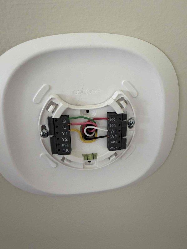 Completed AC start-up on new installation. Verified ecobee thermostat wiring configuration with proper connections at terminal block including C, Y, G, W, Rc, and Rh wires. Inspected ductwork and PVC condensate drain lines in mechanical area, confirmed all components properly installed and system operational.