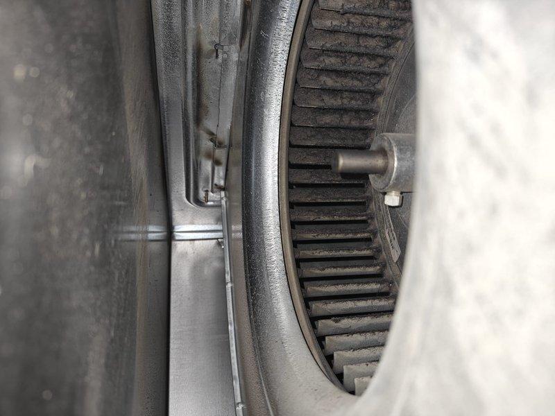 Completed comprehensive AC tune-up including inspection of air handler blower assembly and evaporator coil section. Inspected blower wheel for proper operation and noted dust accumulation on housing and interior components. Examined refrigerant line set showing normal oxidation on copper piping with insulation intact, and verified all mechanical connections secure and operational.