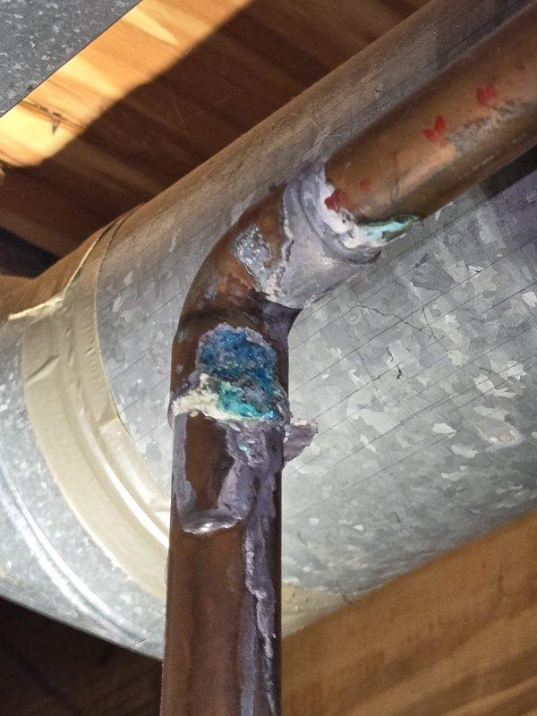 Completed comprehensive AC tune-up including inspection of attic-mounted HVAC system with examination of ductwork insulation, refrigerant lines, and copper piping connections. Performed water heater flush service on gas water heater, inspecting Honeywell gas control valve, brass fittings, and plumbing connections for proper operation and safety compliance.