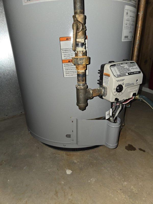 Completed comprehensive AC tune-up including inspection of attic-mounted HVAC system with examination of ductwork insulation, refrigerant lines, and copper piping connections. Performed water heater flush service on gas water heater, inspecting Honeywell gas control valve, brass fittings, and plumbing connections for proper operation and safety compliance.