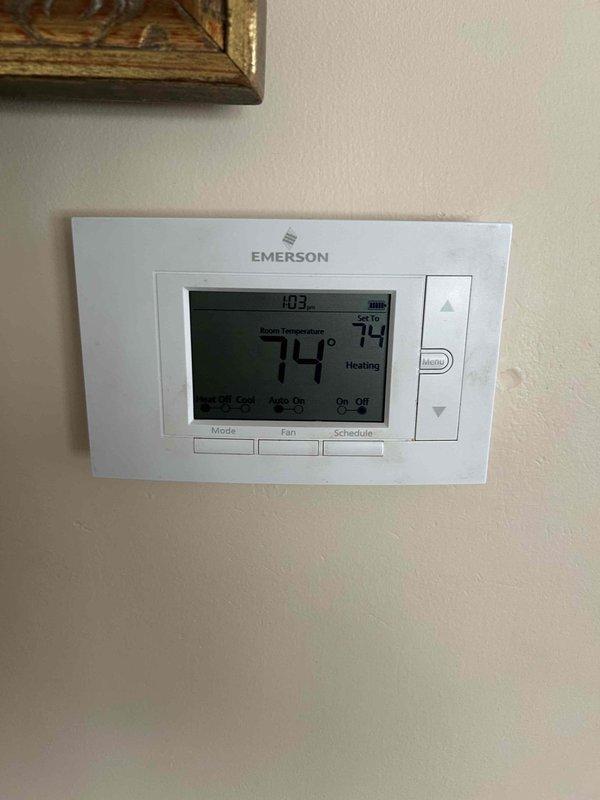 Conducted comprehensive assessment of existing heating system for furnace replacement. Evaluated current Emerson digital thermostat displaying 74° in heating mode and documented electrical panel configuration showing dual columns of circuit breakers with main breaker compartment. Reviewed system specifications and existing infrastructure to determine replacement requirements. Provided customer with financing options for furnace replacement project.
