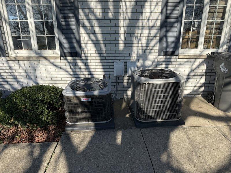 Conducted site visit to review previously provided estimate for air conditioning system and boiler replacement. Evaluated current placement of two outdoor condenser units positioned on concrete pad adjacent to building exterior and discussed relocation options with homeowner. Documented existing equipment configuration, electrical connections, and refrigerant line routing to assess feasibility of relocating AC unit to alternative location on property.
