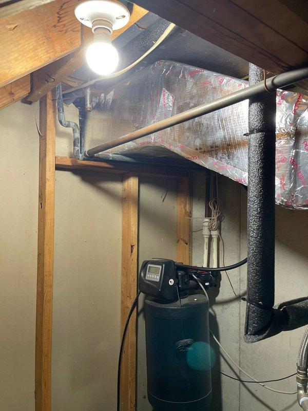 Removed deteriorated duct board supply ductwork from basement utility area and installed new duct board supply with proper insulation and sealing. Reconnected all existing supply ducts to new trunk line, ensuring proper airflow distribution throughout the system. Installed new Aprilaire E100 whole-home dehumidifier and integrated ducting into the return air plenum of the HVAC system to provide humidity control and improve indoor air quality.