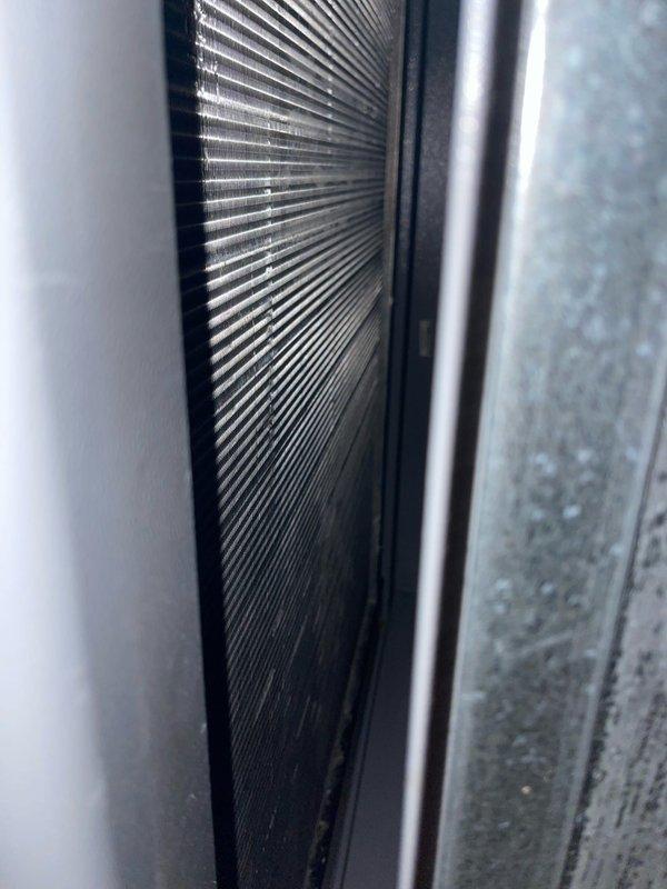 Completed routine cooling maintenance on geothermal HVAC system located in attic crawl space. Inspected heat exchanger coil and air handler unit, noting moderate dust accumulation on aluminum fins and surrounding components. Documented system condition with photographic evidence showing operational equipment with minor debris buildup typical for scheduled maintenance interval.
