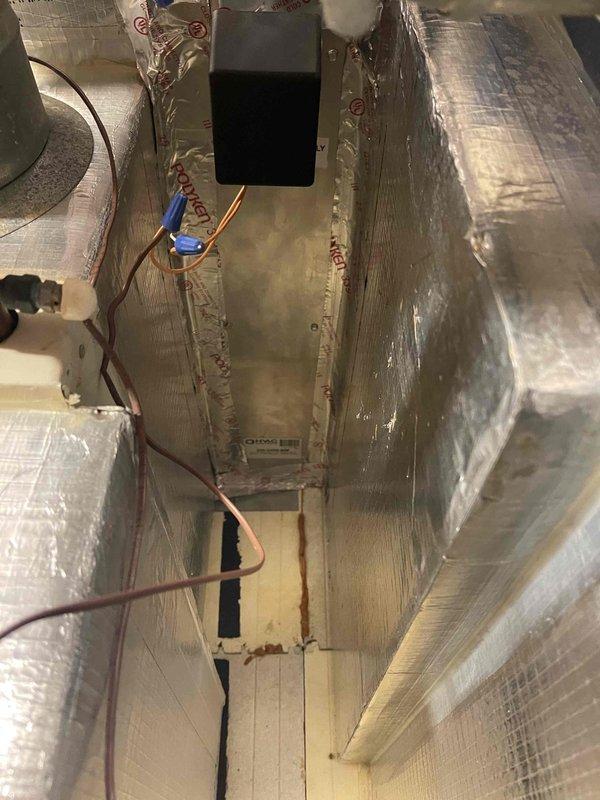Responded to no cooling complaint on main floor air handler unit. Inspected attic-mounted air handler with foil-wrapped insulation and verified electrical connections and ductwork configuration. Examined basement components including cylindrical mesh air filter and associated mechanical equipment to diagnose system operation and airflow issues.
