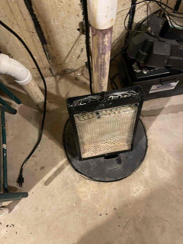 Responded to no cooling complaint on main floor air handler unit. Inspected attic-mounted air handler with foil-wrapped insulation and verified electrical connections and ductwork configuration. Examined basement components including cylindrical mesh air filter and associated mechanical equipment to diagnose system operation and airflow issues.