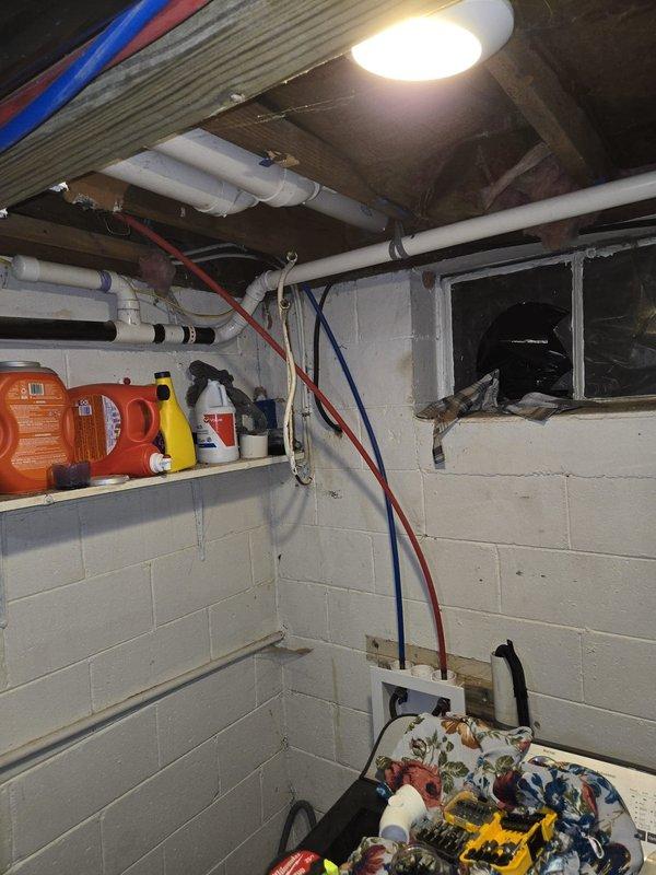 Completed full HVAC system installation in basement utility area. Installed new condensate drain line using white PVC piping with proper vertical routing from ceiling to floor-mounted drain fitting, secured all plumbing connections, and ran electrical wiring with appropriate conduit and outlet boxes to support new equipment. Verified all mechanical systems operational, ensured proper drainage flow, and completed financing paperwork per customer request.