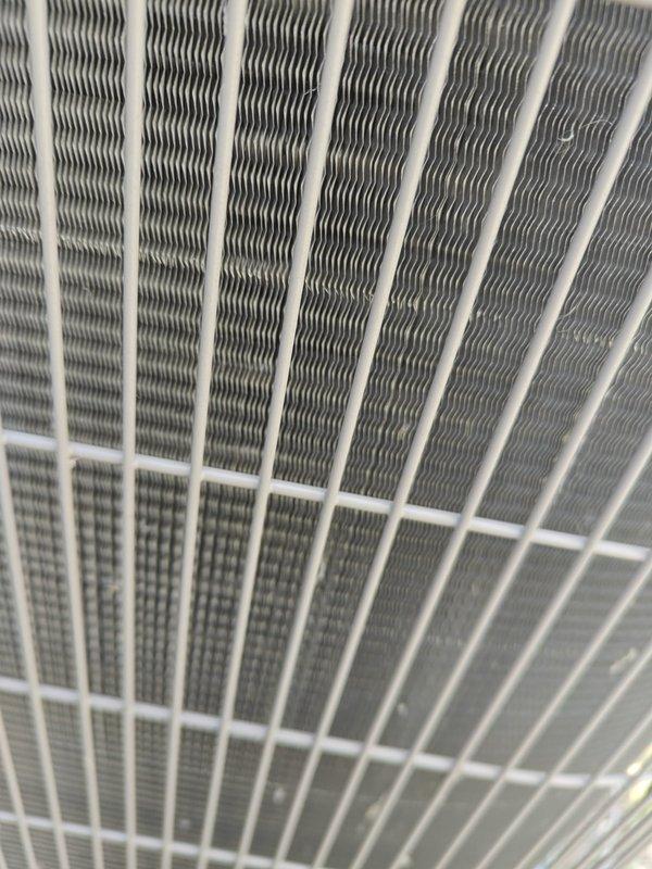 Completed routine cooling maintenance on residential air conditioning system. Inspected condenser unit coil fins, which were found to be clean and in good condition with proper airflow through protective grille. Performed electrical diagnostics using clamp meter to verify system amperage draw of 0.2 amps, checked wire connections at control panel, and confirmed all electrical components were functioning within normal operating parameters.