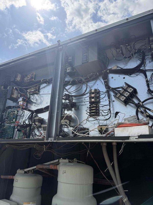 Performed comprehensive diagnostic evaluation on 30+ year old commercial rooftop unit per maintenance request for second opinion assessment. Thoroughly inspected electrical components, contactors, circuit breakers, and wiring connections throughout control panel. Examined condenser coils for reported damage, evaluated condenser fan assemblies, and assessed overall unit condition including ductwork connections and structural integrity. Documented all findings with photographic evidence of electrical panel configuration and mechanical components for maintenance records and future repair recommendations.