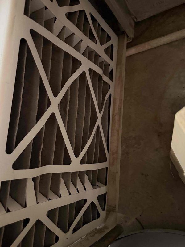 Completed new system start-up and first cooling maintenance service for 2026 season. Inspected HVAC system components including air handler unit and filtration system. Documented pleated air filters installed in furnace assembly, noting standard accordion-style filters with cardboard frames featuring diagonal cross-bracing design. Filters showed normal dust accumulation consistent with operational system. Verified proper filter installation and positioning within metal housing. Observed minor dirt and dust streaks on filter frame edges, typical for systems in active service. Confirmed adequate air filtration media condition with gray pleated construction providing appropriate surface area for particle capture. System operational and ready for cooling season.