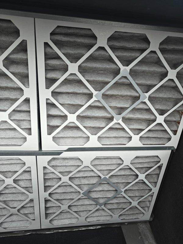 Completed scheduled maintenance agreement filter replacement on commercial HVAC system. Removed and replaced four 16x20x2 filters and one 20x20x1 filter that showed moderate dust and debris accumulation. All filters were properly installed and system airflow verified upon completion.