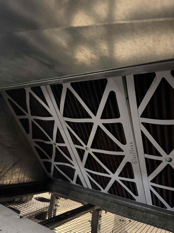 Responded to commercial AC unit leaking water in breakroom area. Upon inspection, found clogged condensate drain line causing water to overflow from drain pan onto floor. Cleared obstruction from drain line, verified proper drainage flow, and inspected evaporator coil and filter for additional issues. Cleaned dirty air filter and drain pan, tested unit operation to confirm leak resolved and proper cooling function restored.
