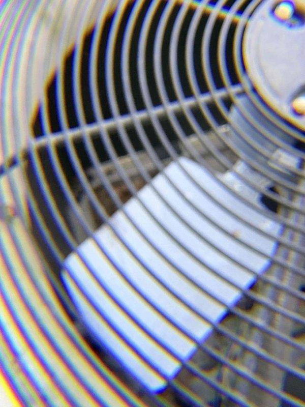 Completed preventive maintenance tune-up on residential HVAC system. Inspected and photographed pleated air filter in air handler unit, confirming proper installation and condition. Performed visual inspection of outdoor condenser unit, including condenser fan assembly and protective grille, verifying fan blade operation and structural integrity of all components.