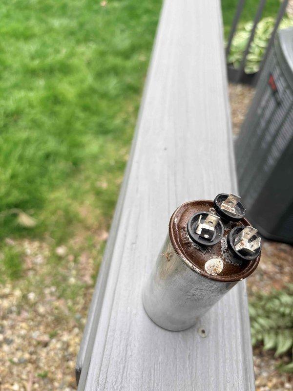 Responded to no cooling complaint with buzzing noise at condenser unit. Upon arrival, found Trane outdoor condensing unit inoperative with audible buzzing from compressor attempting to start. Diagnosed failed run capacitor preventing compressor from starting properly. Removed defective capacitor showing visible corrosion and terminal deterioration. Replaced capacitor with proper OEM equivalent, verified correct microfarad rating and voltage specifications. Cycled system through complete cooling cycle, confirmed compressor started smoothly without buzzing, verified proper amp draw on compressor and condenser fan motor, and confirmed adequate airflow through condenser coil. System restored to normal cooling operation.