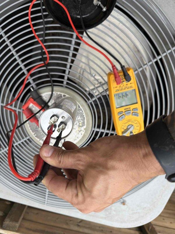 Responded to no cooling complaint on residential HVAC system. Upon arrival, confirmed furnace blower was operating but system was not producing cool air. Performed diagnostic testing on outdoor condensing unit, including electrical measurements at the fan motor assembly to assess component functionality and identify the cause of cooling failure. Documented equipment conditions and test results, then provided repair recommendations to restore proper cooling operation.