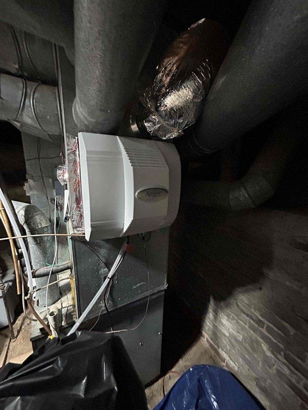 Completed full system replacement estimate for existing HVAC installation. Documented current equipment configuration including furnace control cabinet wiring, Aprilaire humidifier integration with ductwork system, and overall mechanical layout in attic space. Photographed existing electrical connections, relay components, and duct arrangement to provide comprehensive assessment for complete system replacement proposal.
