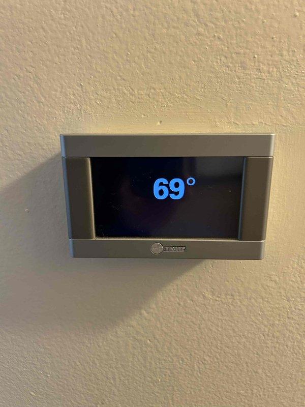 Completed HVAC system replacement estimate for residential property. Assessed existing electrical panel configuration with dedicated circuits for rooms A/C, furnace, and hot tub to verify compatibility with replacement equipment. Evaluated current Trane thermostat functionality and documented system operating at 69°F setpoint for replacement planning specifications.