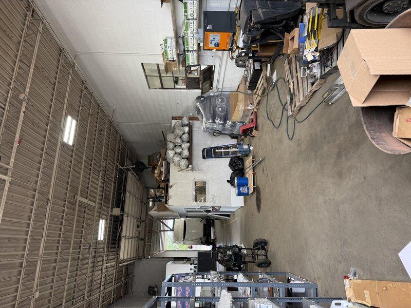 Conducted site assessment for ductless mini-split system installation in commercial warehouse facility covering office area and breakroom. Evaluated existing HVAC infrastructure, documented facility layout including ceiling-mounted fluorescent lighting and electrical specifications, and photographed equipment data plates to determine load requirements and compatibility for multi-zone mini-split configuration.
