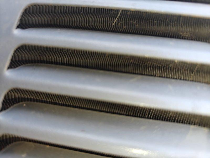 Completed air conditioning tune-up service including comprehensive system inspection and maintenance. Inspected evaporator coil and noted moderate dust accumulation on fins; inspected blower wheel assembly and housing, confirming proper condition and operation. All components found operational with routine wear consistent with normal use.