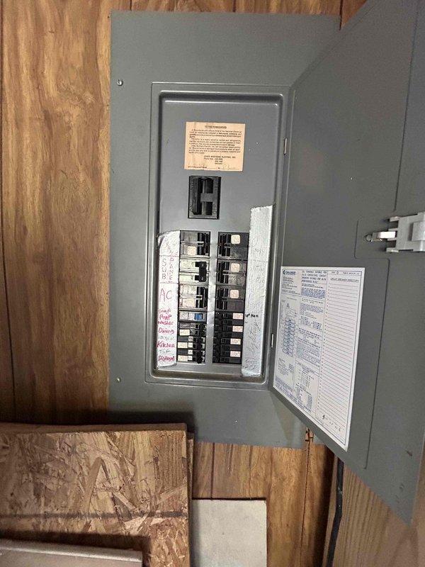Conducted comprehensive site evaluation for complete HVAC system replacement in total electric home serviced by AES utility provider. Assessed existing electrical infrastructure including main service panel with dual-row circuit breaker configuration and current Honeywell digital thermostat displaying 73°F ambient temperature. Documented electrical service capacity, available breaker positions, and compatibility requirements for new all-electric heating and cooling equipment installation.