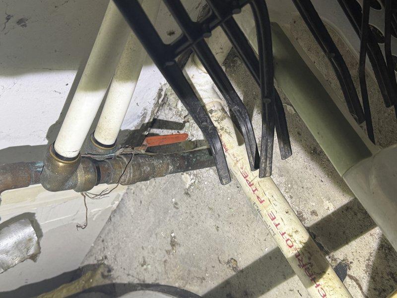 Conducted comprehensive assessment for water heater replacement and tankless unit installation. Inspected existing conventional water heater system, documented aged copper supply piping with significant oxidation and corrosion on surfaces and brass fittings, indicating extended service life and potential leak concerns. Evaluated existing plumbing connections, noting corroded metal piping with rust formation at joints and transitions to PVC supply lines with foam insulation. Assessed utility space configuration and clearances for tankless water heater installation requirements. Additionally identified and documented ductwork concerns in basement area, including bundled electrical conduits and HVAC components requiring attention. Photographed existing conditions showing water heater connections, supply line deterioration, and overhead mechanical systems for estimate preparation. Provided recommendations for complete water heater replacement with tankless system installation and necessary