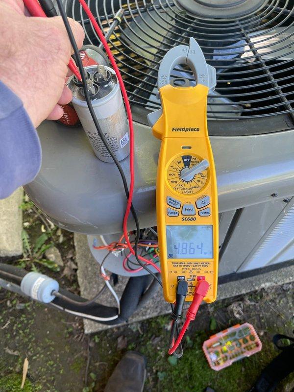 Performed comprehensive diagnostic evaluation of outdoor air conditioning condenser unit to provide full system replacement estimate. Utilized Fieldpiece SC680 clamp meter to measure electrical parameters including voltage, amperage, and capacitance values at the capacitor and electrical components. Tested system performance, inspected fan motor assembly, and evaluated overall unit condition to determine replacement specifications and requirements.