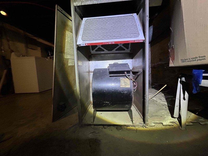 Conducted comprehensive assessment of existing HVAC system in older residential property requiring full system replacement estimate. Evaluated aging furnace unit with exposed blower motor assembly and existing ductwork infrastructure throughout basement utility area. Documented current equipment condition including oversized legacy furnace, existing metal ductwork with insulated branch configurations, and filter housing assembly. Customer seeking complete heating and cooling system replacement for home that has never had air conditioning installed. Provided detailed measurements and photographic documentation of mechanical room layout, existing duct runs, available installation space, and utility connections to prepare accurate replacement system proposal incorporating new furnace and air conditioning components utilizing existing ductwork where feasible.