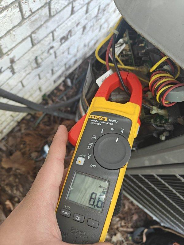 Completed scheduled cooling maintenance on residential air conditioning system. Performed electrical diagnostics using clamp meter, recording compressor amperage at 8.6 amps and additional circuit measurement at 1.7 amps, confirming all electrical components operating within normal parameters. Inspected outdoor condensing unit, verified proper wire connections, and assessed refrigerant lines and insulation condition with no issues found.