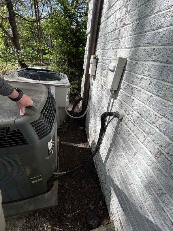 Conducted comprehensive site evaluation for HVAC system replacement at residential property. Assessed existing dual outdoor condenser unit configuration, including refrigerant line routing, electrical disconnect, and mounting pad condition. Documented current electrical service panel capacity with three-panel array to verify adequate power supply for potential full system upgrade. Evaluated feasibility of complete air conditioning replacement versus full heating and cooling system installation based on existing infrastructure and electrical service capabilities.