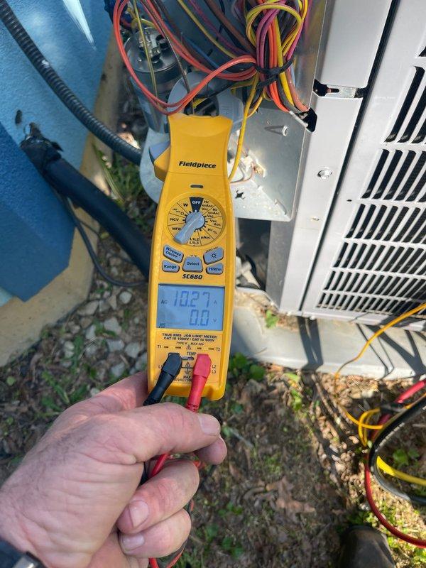 Completed scheduled cooling maintenance on residential HVAC system. Performed electrical diagnostics on outdoor condensing unit using digital multimeter, verifying proper voltage and system operation at terminal connections. Inspected and documented condition of air filter, which showed moderate dust accumulation consistent with normal usage.