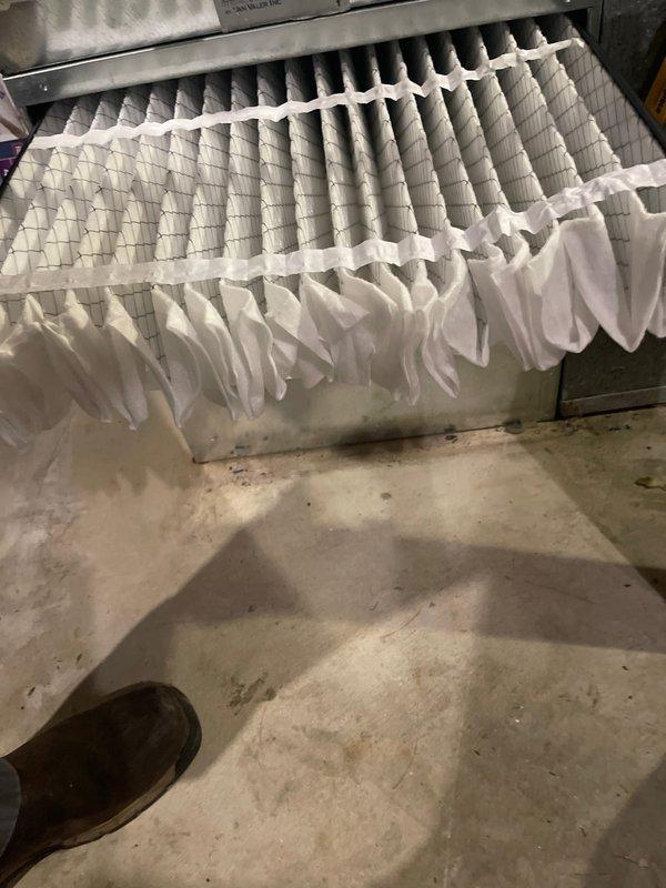 Completed air conditioning tune-up service on residential HVAC system. Inspected existing air filter which showed moderate dust accumulation and discoloration from normal use. Installed new pleated air filter in system housing to ensure proper airflow and filtration efficiency for optimal system performance.