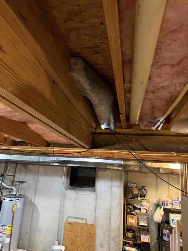 Responded to service call for basement AC unit experiencing excessive condensation and water leakage in area being converted to gym space. Performed inspection of HVAC system and ductwork installation, documenting existing conditions with photos showing uninsulated flexible ductwork running through exposed basement ceiling joists. Provided quote for duct insulation wrapping to eliminate condensation issues and improve system efficiency, with same-day installation available upon approval.