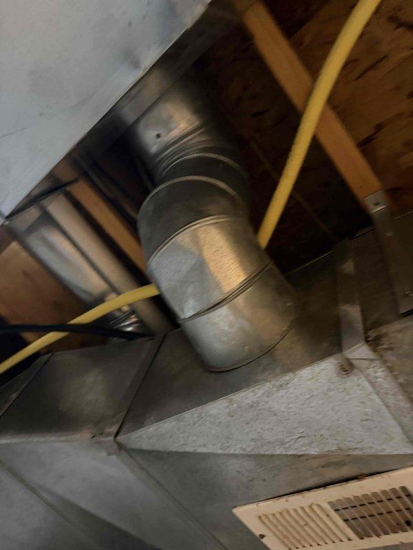 Responded to service call for basement AC unit experiencing excessive condensation and water leakage in area being converted to gym space. Performed inspection of HVAC system and ductwork installation, documenting existing conditions with photos showing uninsulated flexible ductwork running through exposed basement ceiling joists. Provided quote for duct insulation wrapping to eliminate condensation issues and improve system efficiency, with same-day installation available upon approval.