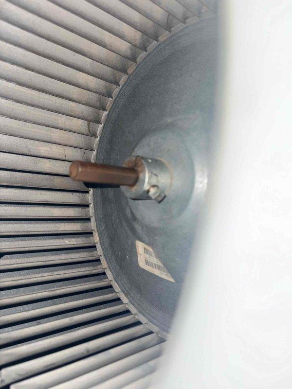 Completed air conditioning tune-up on rooftop unit. Performed electrical measurements using clamp meter, recording voltage and amperage readings at 24.3 amps. Inspected condenser fan motor assembly, verified proper operation of motor shaft and cooling fins, and confirmed all components functioning within normal parameters.