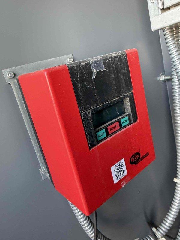 Responded to no heat or cool complaint in Industrial Engineering office on 2nd floor B Wing. Performed diagnostic inspection of HVAC system and thermostat controls. Inspected Trane programmable thermostat with protective cover showing display reading 66 degrees and 4:10 time, confirmed all control buttons operational. Examined red electronic control panel mounted on wall with LCD display and control functions for SCROLL, RESET, and MORE buttons. Documented system components and current settings with photos for repair cost estimation and approval process prior to completing necessary repairs.