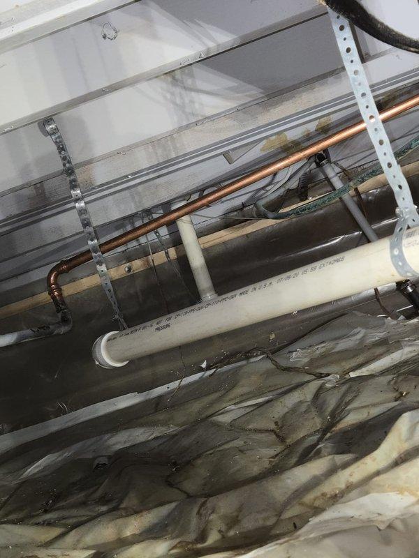 Responded to service call for boiler system modifications due to exposed kitchen ceiling from water damage incident. Performed diagnostic assessment of boiler piping system, specifically evaluating the hydronic supply line running from boiler to upstairs bathroom radiator and identifying downstairs radiator for removal. Inspected existing copper and PEX piping infrastructure in exposed ceiling cavity, documented current configuration of heating distribution system including insulated supply lines, return piping, and support brackets. Assessed condition of piping connections, hangers, and insulation material throughout affected area. Provided customer with evaluation of required repairs to bathroom heating line and scope of work for radiator removal from downstairs zone.