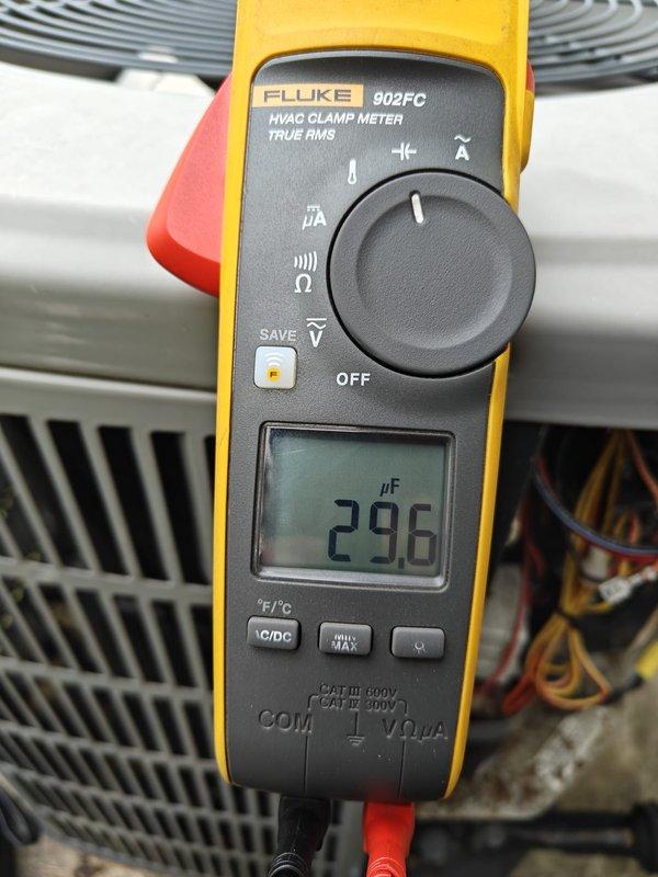 Completed comprehensive AC tune-up including electrical diagnostics and capacitor testing. Measured blower motor current draw at 5.8 amps AC and tested run capacitor reading 29.6 microfarads, both within normal operating parameters. All system components inspected and operating efficiently.