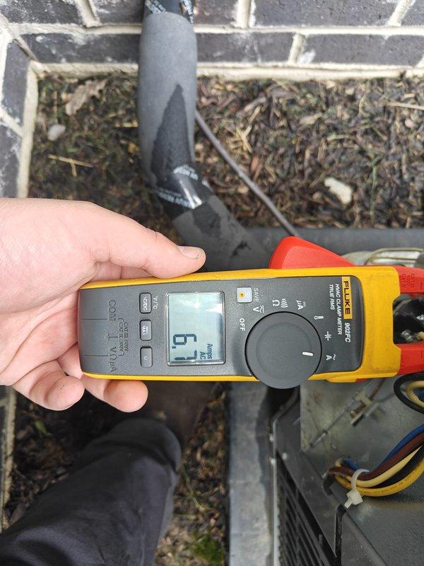 Completed routine cooling maintenance on residential HVAC system. Performed electrical diagnostics using digital clamp meter, recording amperage draw of 5 amps at outdoor condensing unit. Inspected and cleaned exterior condenser coil, removing accumulated debris including leaves, twigs, and organic matter from unit and surrounding drainage channels. Verified electrical connections and measured system voltage at 80 volts during testing sequence. All components operating within normal parameters upon completion of maintenance service.