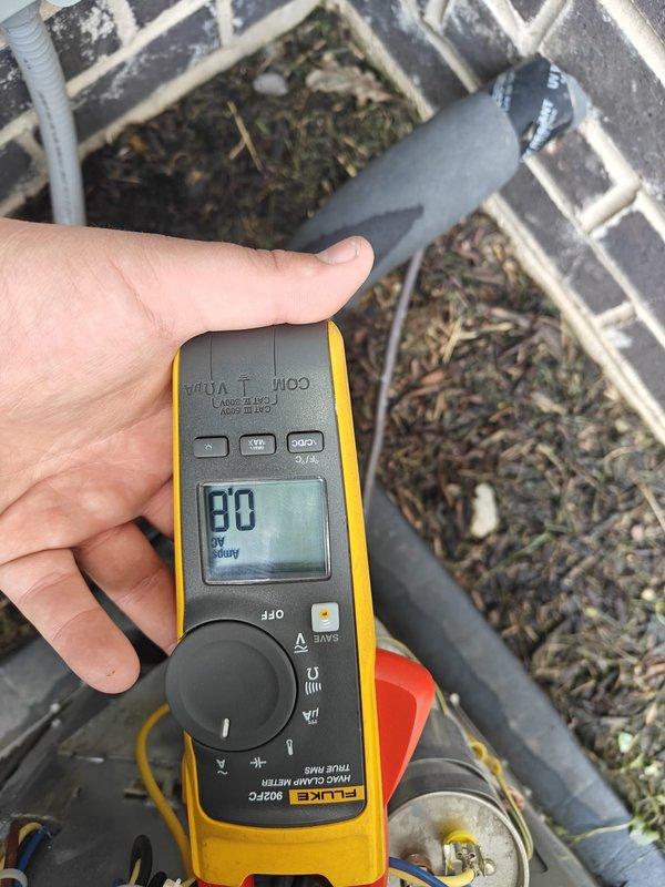 Completed routine cooling maintenance on residential HVAC system. Performed electrical diagnostics using digital clamp meter, recording amperage draw of 5 amps at outdoor condensing unit. Inspected and cleaned exterior condenser coil, removing accumulated debris including leaves, twigs, and organic matter from unit and surrounding drainage channels. Verified electrical connections and measured system voltage at 80 volts during testing sequence. All components operating within normal parameters upon completion of maintenance service.