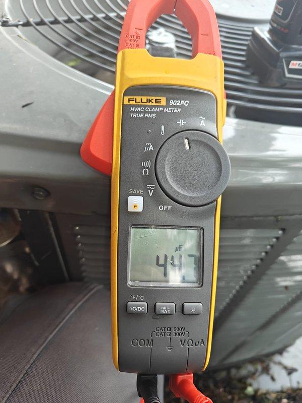 Completed comprehensive AC tune-up on residential cooling system, performing standard maintenance protocol including electrical diagnostics and performance testing. Measured capacitance readings at 417 μF using calibrated clamp meter to verify compressor and fan motor operation within manufacturer specifications. Inspected outdoor condenser unit components including fan assembly, motor housing, and heat exchanger coils, confirming all equipment operating properly with maintenance plan renewal processed.