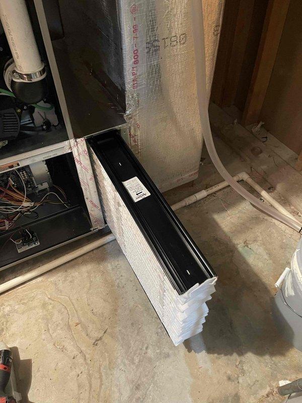 Completed HVAC install warranty inspection in basement utility area. Verified proper installation of Carrier heating and cooling equipment with associated PVC drainage and ventilation piping, confirmed floor register placement and operation, and documented proper insulation installation in wall cavities. All components functioning as designed with no deficiencies noted.